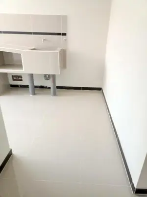 a white bathroom with a sink and a mirror at Casa Alojamiento Virreynal in San Ramón
