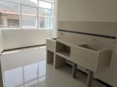 a white bathroom with a sink and a window at Casa Alojamiento Virreynal in San Ramón