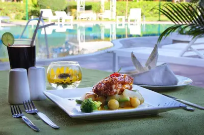 a plate of food on a table with a drink at Hotel Villa de Valverde in Ica