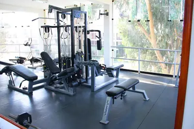 a gym with several tread machines in a room at Hotel Villa de Valverde in Ica