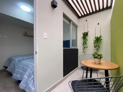 a room with a table and chairs and a bed at Silvia's New Spacious Patio Pad in Lima