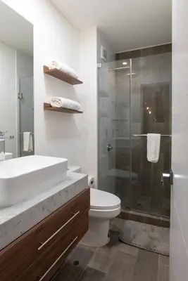 a bathroom with a sink and a toilet and a shower at Silvia's New Spacious Patio Pad in Lima