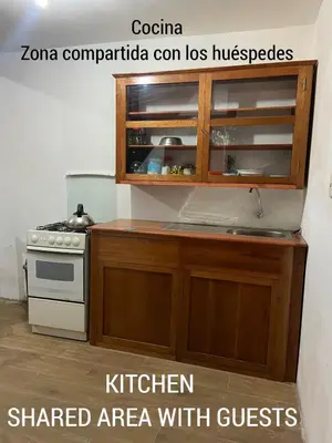 a kitchen with a stove and a kitchen shared area with guests at CASA ALVAREZ in Cusco