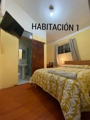 a bedroom with a bed and a flat screen tv at CASA ALVAREZ in Cusco