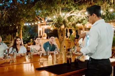 a man standing at a table with a group of people at Hotel Fundo El Arrabal in Ica