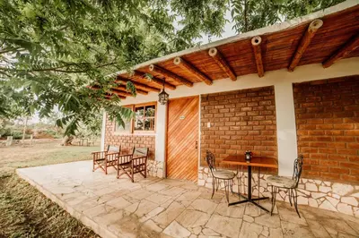 a patio with chairs and a table and a building at Hotel Fundo El Arrabal in Ica
