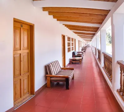 a row of chairs on the porch of a house at Hotel El Huarango in Ica