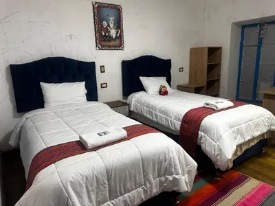a bedroom with two beds with towels on them at AITANA'S HOUSE - SAN BLAs in Cusco
