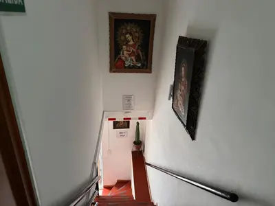 a hallway with a staircase with a painting on the wall at Hostal El Auqui in Cusco