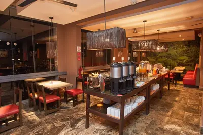 a restaurant with tables and chairs and a bar at Casa Andina Standard Machu Picchu in Machu Picchu