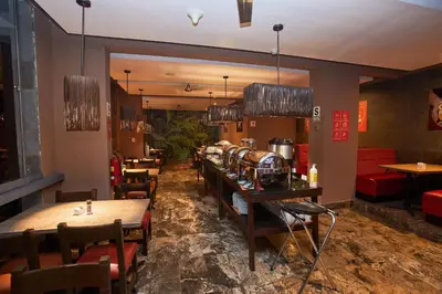 a restaurant with tables and chairs in a room at Casa Andina Standard Machu Picchu in Machu Picchu