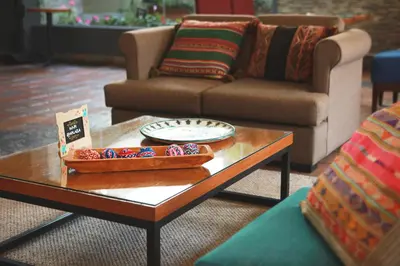 a living room with a coffee table and a couch at San Agustin Plaza in Cusco