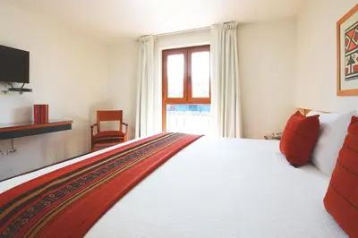 a bedroom with a large bed and a window at San Agustin Plaza in Cusco