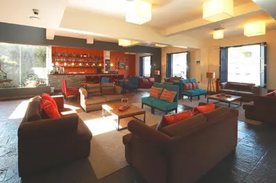 a large living room with couches and chairs at San Agustin Plaza in Cusco