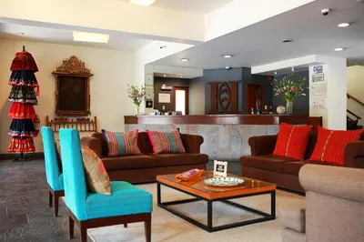 a living room with couches and a coffee table at San Agustin Plaza in Cusco