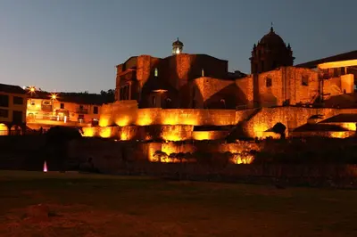 a building with lights in front of it at night at San Agustin Plaza in Cusco