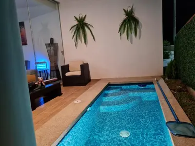 a swimming pool in the middle of a living room at Departamento de Playa (con piscina propia) en km 107 Asia, Lima in Asia
