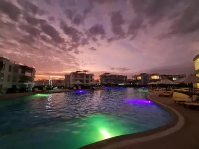 a pool with lights in the water at night at Departamento de Playa (con piscina propia) en km 107 Asia, Lima in Asia