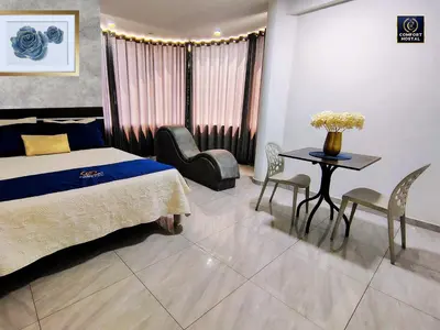 a bedroom with a bed and a table and chairs at Hospedaje Comfort Lima in Lima