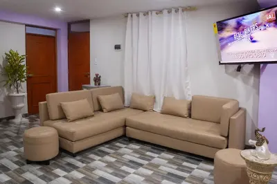 a living room with a couch and a flat screen tv at TRANSFER VIP HOSTEL in Lima