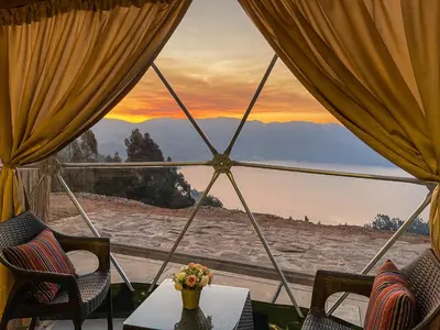 a view from a room with a table and chairs at Pacucha Glamping in Andahuaylas