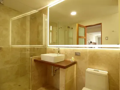 a bathroom with a sink and a shower and a toilet at Muña Hotel Andahuaylas in Andahuaylas