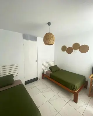 a bedroom with two beds in a room at Hostel Killamoon Centro in Paracas