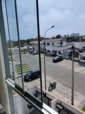 a view of a parking lot from a window at Excelente departamento frente al mar. in San Bartolo
