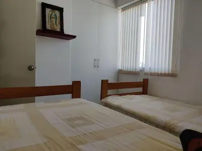 a bedroom with two beds and a window at Excelente departamento frente al mar. in San Bartolo