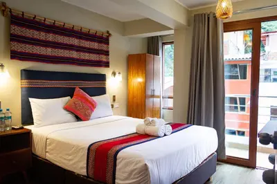 a bedroom with a bed with a teddy bear on it at Rockrivers Plaza MachuPicchu in Machu Picchu