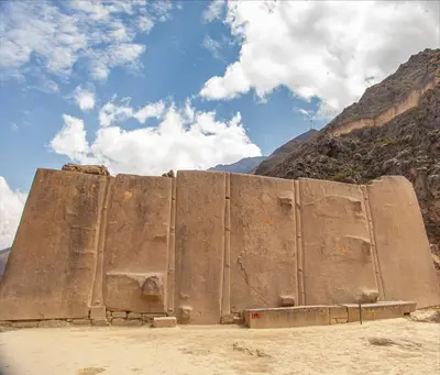a large concrete wall in the middle of a mountain at Hotel Valle Mistico in Ollantaytambo