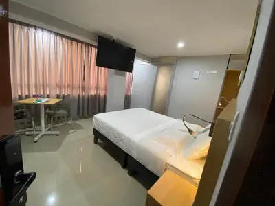 a hospital room with a bed and a desk at Millennium Hotel Corporative in San Vicente de Cañete