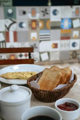 a table with a basket of bread and a plate of toast at The Lot Boutique in Lima