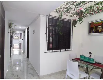 a dining room with a table and a window at Hostel Las Vegas in Lima