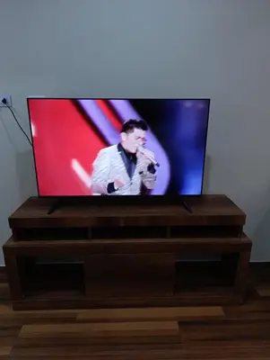 a flat screen tv sitting on top of a wooden stand at Arabian Hotel in Lima