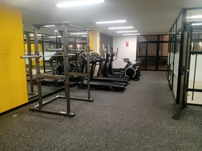 a gym with several tread machines in a room at Habitación nueva para persona sola o pareja in Lima