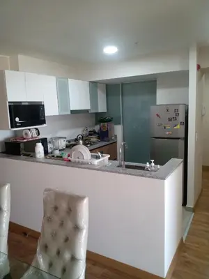 a kitchen with a counter top and a refrigerator at Habitación nueva para persona sola o pareja in Lima