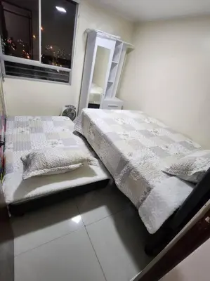 a bedroom with a bed and a ladder next to a window at Departamento amplio y acogedor San Miguel in Lima