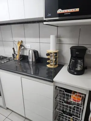 a kitchen with a counter top with a coffee maker at Departamento amplio y acogedor San Miguel in Lima