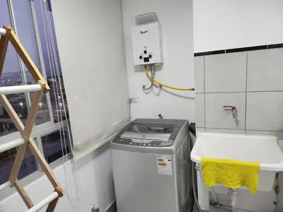 a laundry room with a washing machine and a sink at Departamento amplio y acogedor San Miguel in Lima