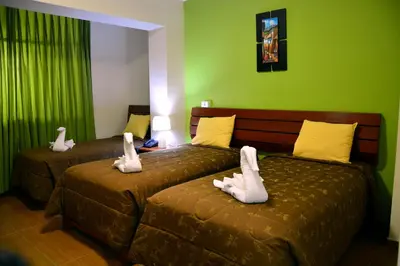 two beds with stuffed animals on them in a room at Hotel Sol del Sur in Nazca