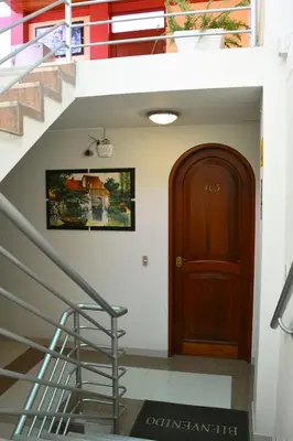 a stairway with a wooden door and a stair case at Hotel Sol del Sur in Nazca