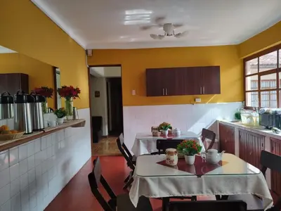 a kitchen with a table and chairs in a room at HOSTAL CASA INKAS in Cusco
