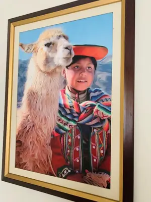 a painting of a boy with a llama at Peruvian House - Miraflores in Lima