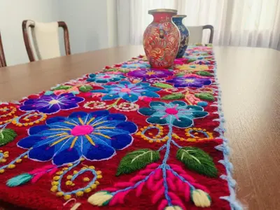 a vase sitting on top of a table with a colorful rug at Peruvian House - Miraflores in Lima