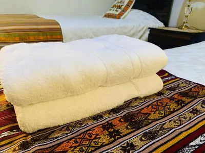 two white towels sitting on top of a bed at Peruvian House - Miraflores in Lima