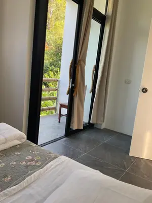 a bedroom with a bed and a door to a balcony at El Cacaotal Finca Faura #5 3H in San Ramón
