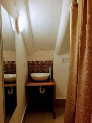 a bathroom with a sink and a mirror at Kori Gems Inn in Cusco