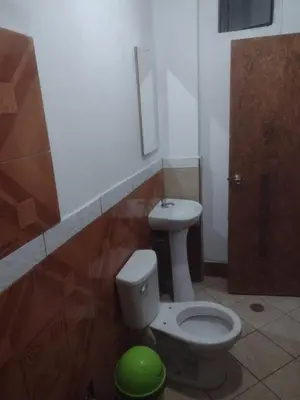 a bathroom with a toilet and a sink at Nomads Club in Nazca