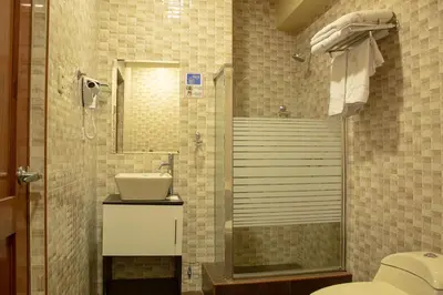 a bathroom with a shower and a toilet and a sink at Hotel B&V in Huancayo